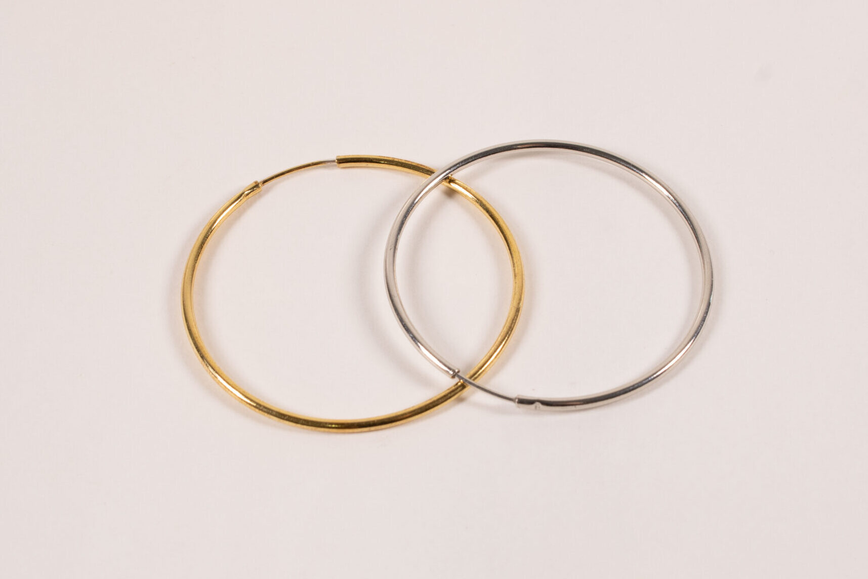 Product image of FredFloris large round hoop gold and silver earrings